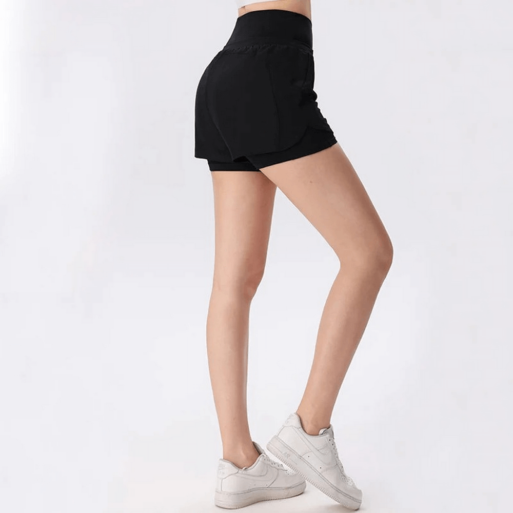 Woman wearing black athletic high waist shorts, showcasing lightweight and breathable design, perfect for warm weather workouts.